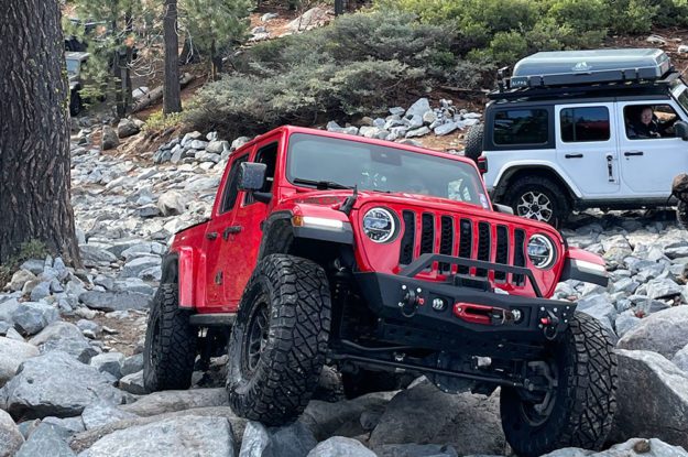 red jeep on granite boulders