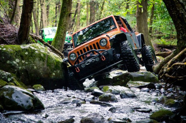 orange jeep in creek