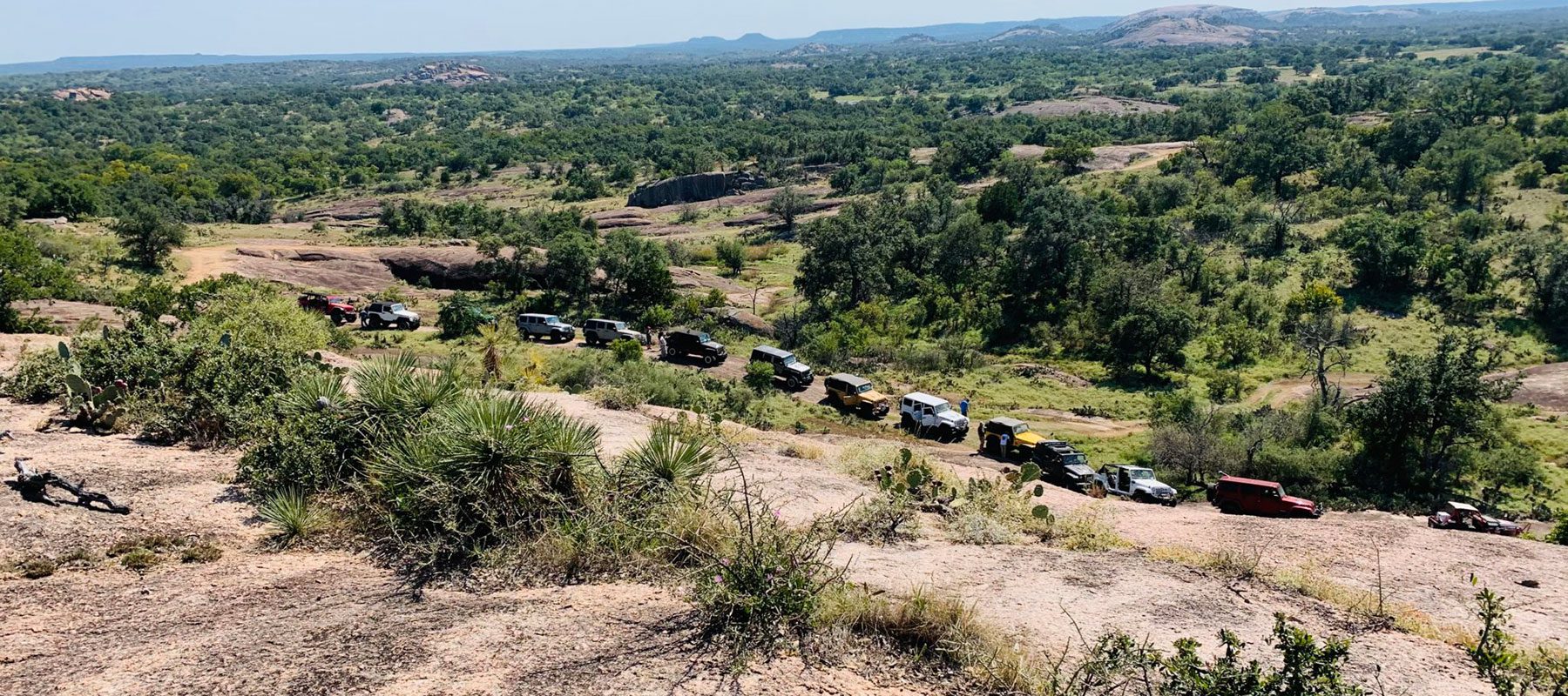 line of jeeps in hills
