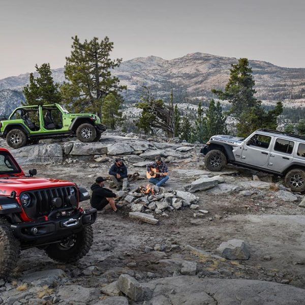 jeeps in a circle around a campfire